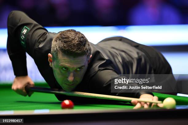 Mark Selby of England plays a shot in his first round match against Robert Milkins of England during day four of the MrQ Masters Snooker 2024 at...