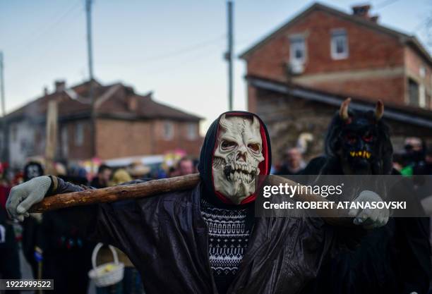 Reveller wears a carnival costume as he takes part in a parade in the village of Vevcani, in southwest Macedonia, on January 13, 2024. The...