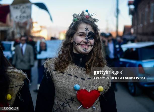 Reveller wears a carnival costume as she takes part in a parade in the village of Vevcani, in southwest Macedonia, on January 13, 2024. The...