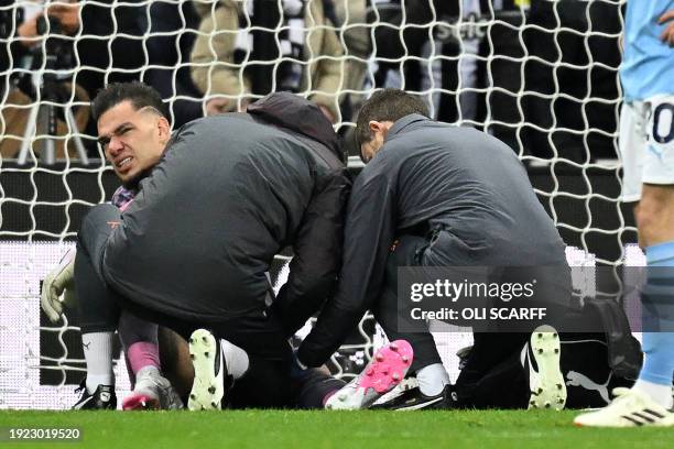 Manchester City's Brazilian goalkeeper Ederson receives medical attention after picking up an injury during the English Premier League football match...