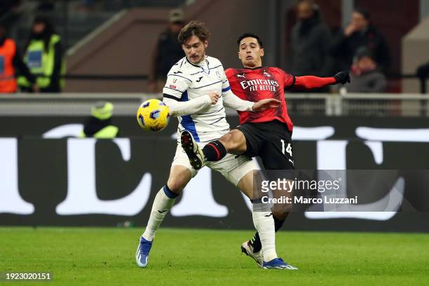 Tijjani Reijnders of AC Milan battles for possession with Aleksey Miranchuk of Atalanta BC during the Coppa Italia match between AC Milan and...