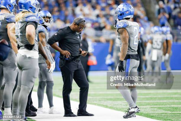 Defensive coordinator Aaron Glenn of the Detroit Lions looks over a play sheet during the second half of a game against the Minnesota Vikings at Ford...