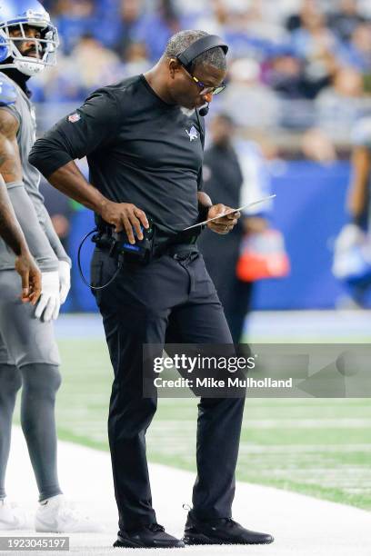 Defensive coordinator Aaron Glenn of the Detroit Lions looks over a play sheet during the second half of a game against the Minnesota Vikings at Ford...