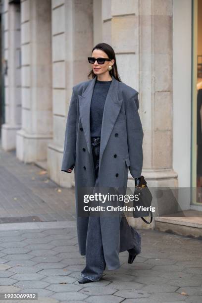 Zina Charkoplia wears grey Frankie Shop coat and sweater, Massimo Dutti Jeans, Proenza Shouler boots, Gigi Studio sunglasses, Hermes bag on January...