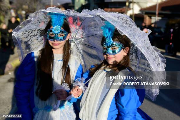 Revellers wear carnival costumes as they take part in a parade in the village of Vevcani, in southwest Macedonia, on January 13, 2024. The...