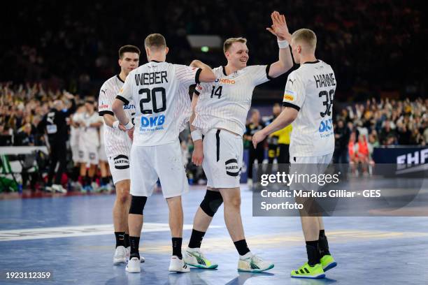 Martin Hanne, Justus Fischer and Philipp Weber of Germany celebrating victory after the Men's EHF Euro 2024 preliminary round match between Germany...