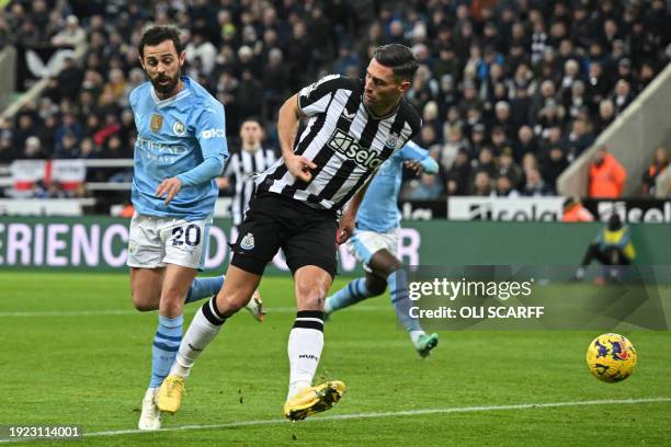 Manchester City's Portuguese midfielder Bernardo Silva scores the opening goal with this flick during the English Premier League football match...