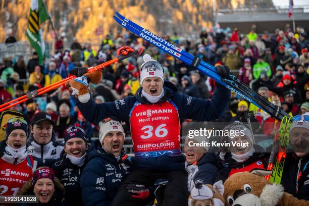 Tarjei Boe of Norway, Vetle Sjaastad Christiansen of Norway and Johannes Dale-Skjevdal of Norway celebrate with the team after the award ceremony for...