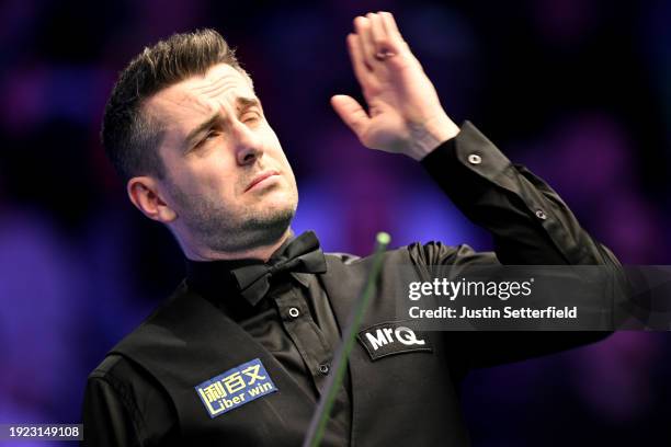 Mark Selby of England swats an insect in his first round match against Robert Milkins of England during day four of the MrQ Masters Snooker 2024 at...