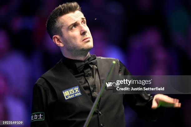 Mark Selby of England swats an insect in his first round match against Robert Milkins of England during day four of the MrQ Masters Snooker 2024 at...