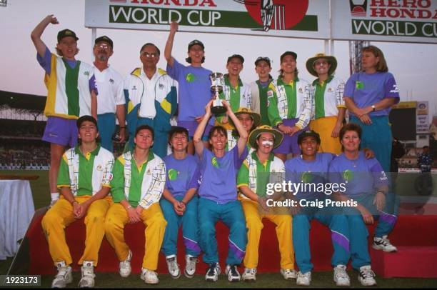 The Australia team group hold aloft the trophy after victory over New Zealand in the Women's Cricket World Cup Final at Eden Gardens in Calcutta,...