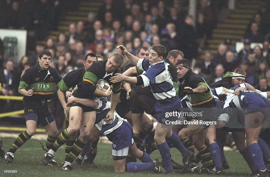 Tim Rodber of Northampton is tackled by Russell Earnshaw and Dan Lyle ...