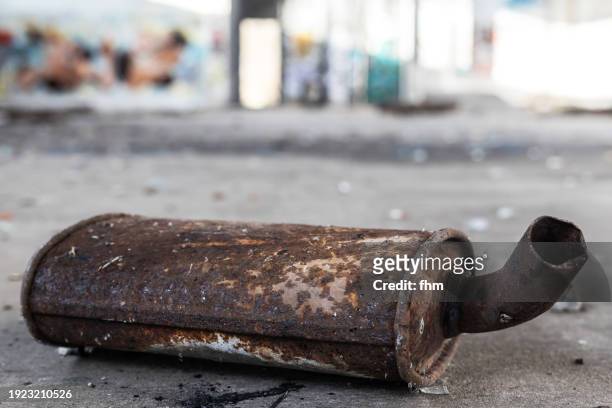 old rusty exhaust pipe of a car in an abandoned workshop - cars on motor way stock-fotos und bilder