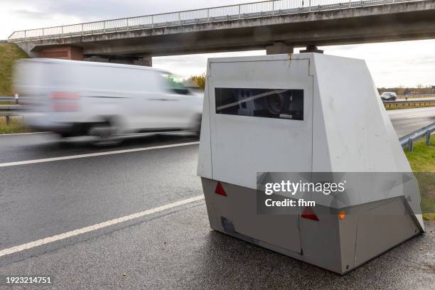 speed camera of the police with passing fast car - thoroughfare stock pictures, royalty-free photos & images