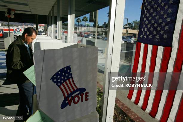 Man votes during the midterm elections 07 November 2006, at a polling station located in an car dealership in Glendale, California, 10 miles north of...