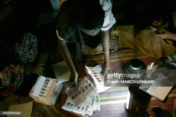 Polling stations officials count ballots 30 October 2005 at the Forodhani school in Stone Town, Zanzibar. Polling stations closed and vote-counting...