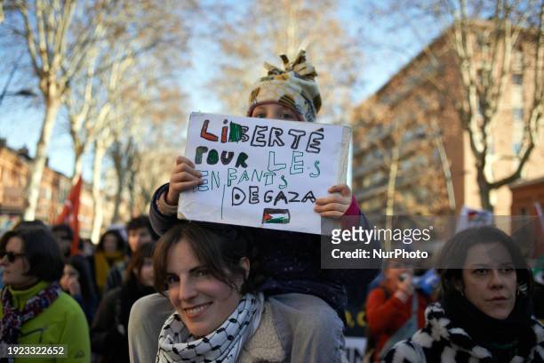 Young girl is holding a sheet that reads 'Freedom for the children of Gaza' as hundreds of people are demonstrating in Toulouse, France, in support...