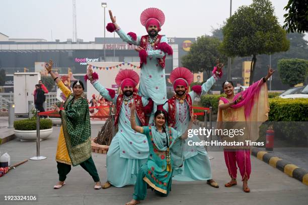 Group of dancers from Punjab performs during the Lohri celebrations at Great India Place Mall sector 38A, on January 13, 2024 in Noida, India.