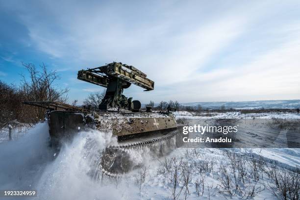 Ukrainian anti-aircraft vehicle drives towards a firing position at the Bakhmut frontline, in Donetsk Oblast, Ukraine on January 13, 2024. Drone and...