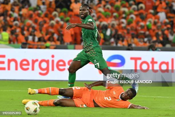 Ivory Coast's defender Ousmane Diomande tackles Guinea-Bissau's forward Mama Balde during the Africa Cup of Nations 2024 group A football match...