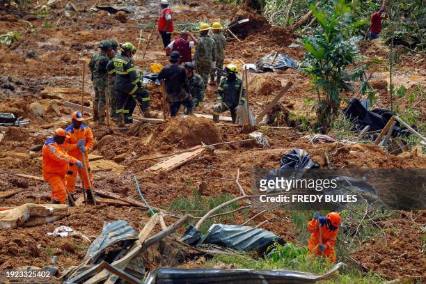Members of the rescue team search for people trapped at the area of a landslide in the road between Quibdo and Medellin, Choco department, Colombia...