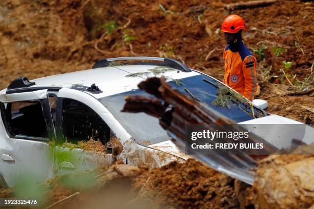 Member of the rescue team searches for people trapped at the area of a landslide in the road between Quibdo and Medellin, Choco department, Colombia...