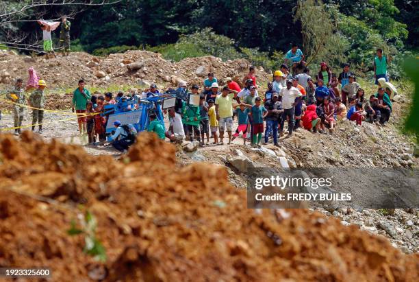 People observe the area where of a landslide in the road between Quibdo and Medellin, Choco department, Colombia on January 13, 2024. At least 33...