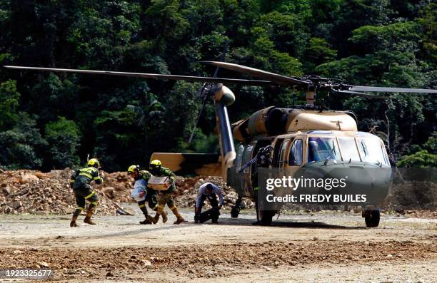 Members of the rescue team arrive at the zone of a landslide in the road between Quibdo and Medellin, Choco department, Colombia on January 13, 2024....