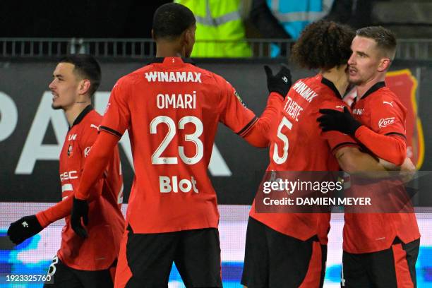 Rennes' French midfielder Benjamin Bourigeaud celebrates with teammates after scoring a goal during the French L1 football match between Stade...