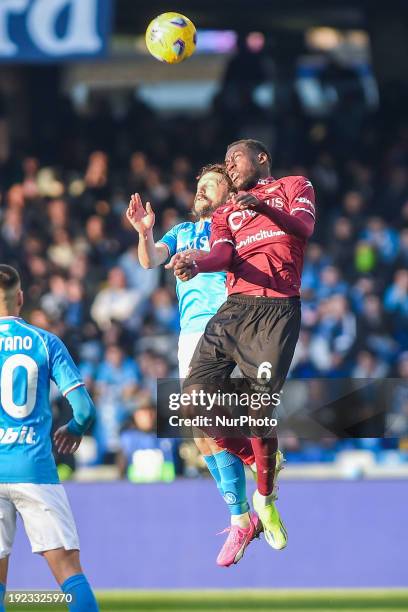 Junior Sambia of US Salernitana competes for the ball with Mario Rui of SSC Napoli during the Serie A TIM match between SSC Napoli and US Salernitana...