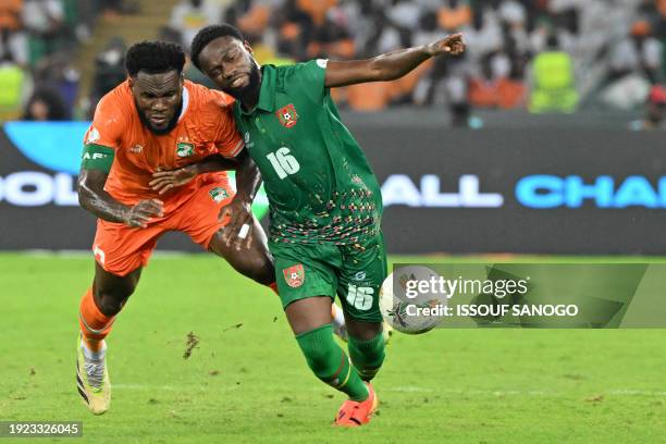 Ivory Coast's midfielder Franck Kessie fights for the ball with Guinea-Bissau's midfielder Moreto Cassama during the Africa Cup of Nations 2024 group...