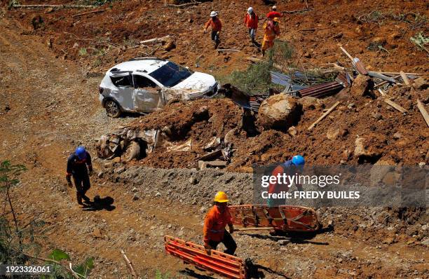 Members of the rescue team search for people trapped at the area of a landslide in the road between Quibdo and Medellin, Choco department, Colombia...