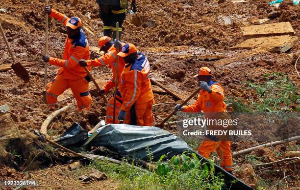 Members of the rescue team search for people trapped at the area of a landslide in the road between Quibdo and Medellin, Choco department, Colombia...