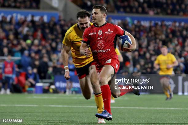 Toulouse's French scrum-half Antoine Dupont runs in his second try during the European Rugby Champions Cup pool 2 rugby union match between Ulster...