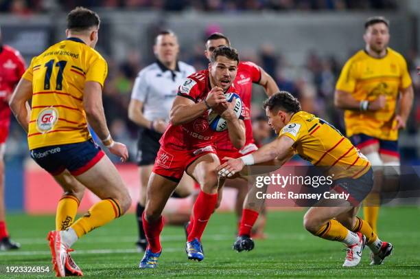 Belfast , United Kingdom - 13 January 2024; Antoine Dupont of Toulouse is tackled by Jacob Stockdale and Mike Lowry of Ulster during the Investec...