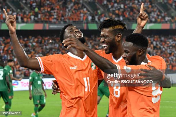 Ivory Coast's forward Jean Philippe Nils Stephan Krasso celebrates with Ivory Coast's midfielder Ibrahim Sangare and Ivory Coast's forward Jonathan...