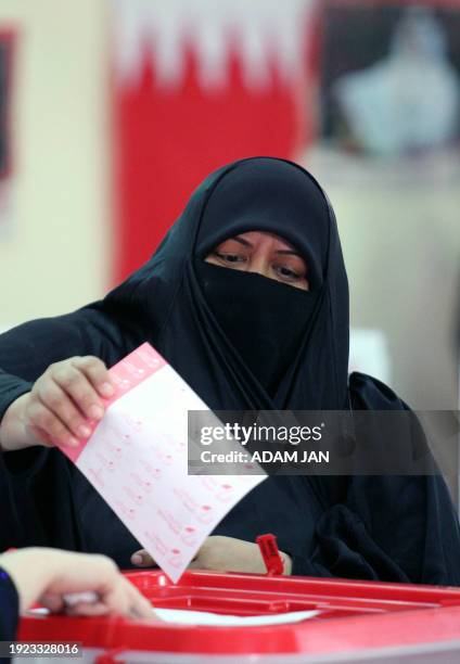 Bahraini woman casts her ballot in the second round of legislative election at a polling station in Manama on October 30, 2010 with the remaining...