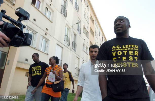 Samir Mihi , Spokesman of French association "A.C LEFEU" walks after voting, flanked by Siyakha Traore , brother of one of the two teenagers who died...