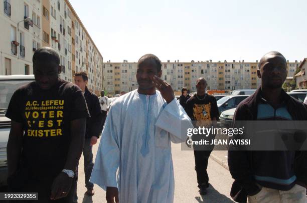Seydou Traore , father of one of the two teenagers who died by electrocution 27 October 2005 as he tried to escape from the police, walks with his...