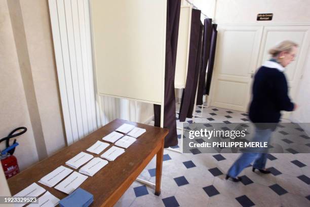 Woman who set up the polling station as it was for the 1st round of the presidential elections, walks past booths, 26 April 2007 in Donzy Burgundy,...