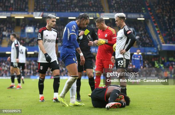 Chelsea's Malo Gusto receives a yellow card from referee Anthony Taylor after his challenge on Fulham's Willian during the Premier League match...