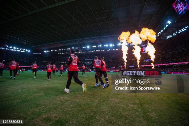 Melbourne Renegades players taking the field during KFC Big Bash League T20 match between Melbourne Renegades and Melbourne Stars at the Marvel...