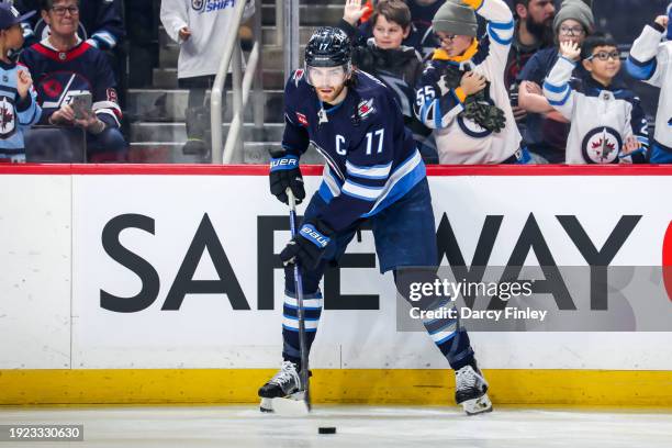 Adam Lowry of the Winnipeg Jets takes part in the pre-game warm up prior to NHL action against the Philadelphia Flyers at the Canada Life Centre on...