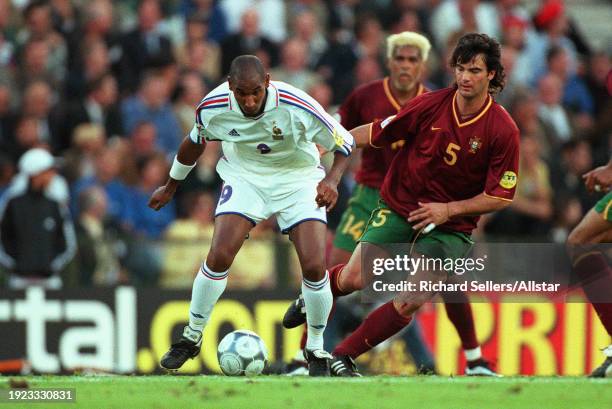 June 28: Nicolas Anelka of France and Fernando Couto of Portugal challenge during the UEFA Euro 2000 Semi Final match between France and Portugal at...