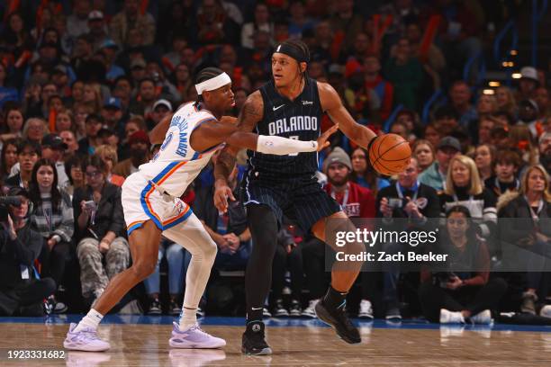 Paolo Banchero of the Orlando Magic handles the ball during the game against the Oklahoma City Thunder on January 13, 2024 at Paycom Arena in...