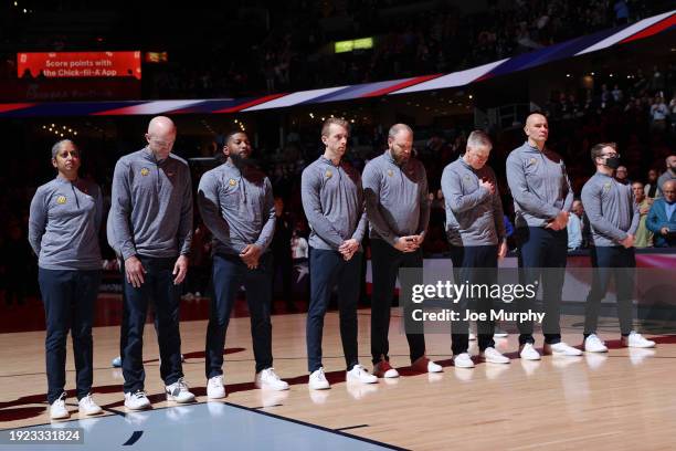 Memphis Grizzlies coaching staff line up during the national anthem before the game against the New York Knicks on January 13, 2024 at FedExForum in...
