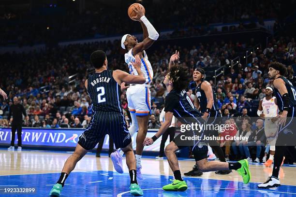 Shai Gilgeous-Alexander of the Oklahoma City Thunder rises up in the paint during the first half against the Orlando Magic at Paycom Center on...