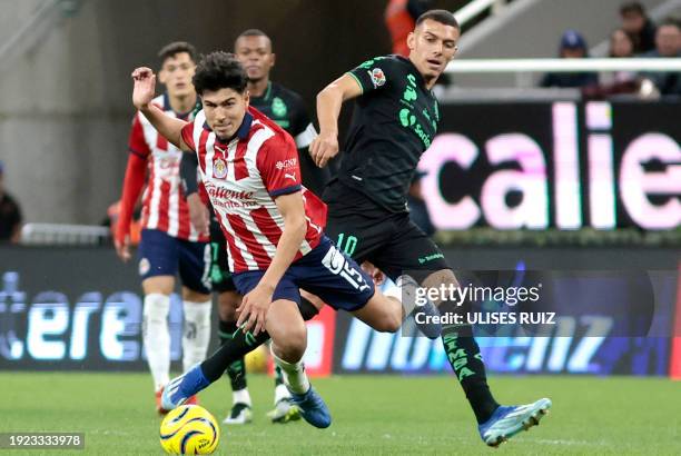 Guadalajara's Erick Gutierrez vies for the ball with Santos' Franco Fagundez during the Mexican Clausura tournament football match between...