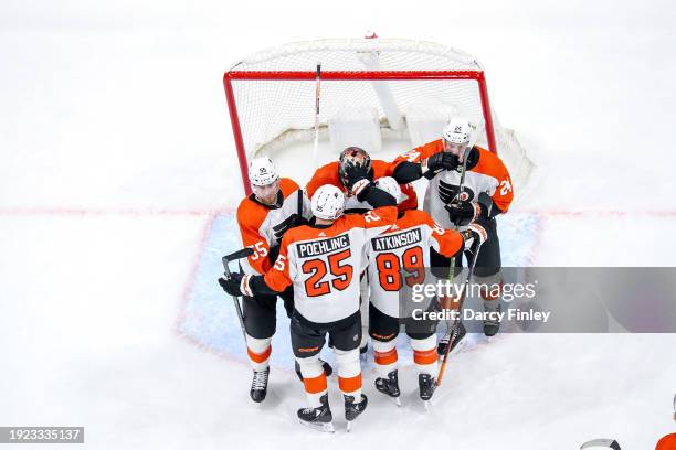 Goaltender Samuel Ersson of the Philadelphia Flyers gets congratulated by teammates following a 2-0 shutout victory over the Winnipeg Jets at the...