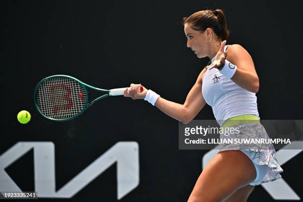 Britain's Jodie Burrage hits a return against Germany's Tamara Korpatsch during their women's singles match on day one of the Australian Open tennis...
